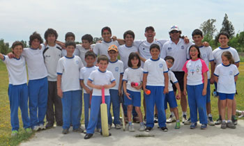 Ian with young cricketers in Chile